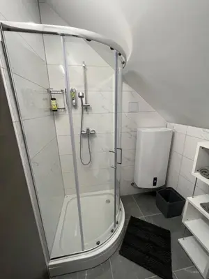 a shower with a glass door in a bathroom at ApartmaSLB in Slovenska Bistrica