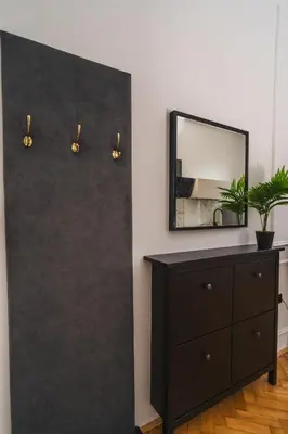 a room with a dresser and a mirror at HL Apartments in Maribor