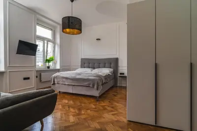 a bedroom with a bed and a couch at HL Apartments in Maribor