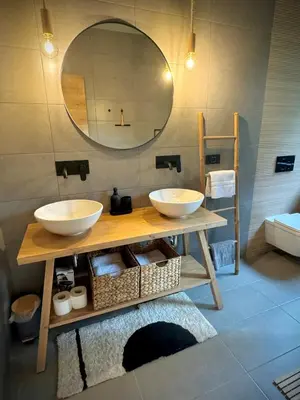 a bathroom with two sinks and a mirror at Mlino Alpino in Bled