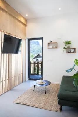 a living room with a couch and a table at Mlino Alpino in Bled