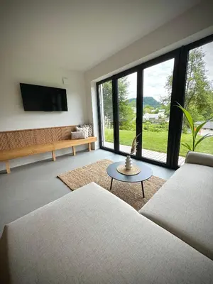 a living room with a couch and a table at Mlino Alpino in Bled