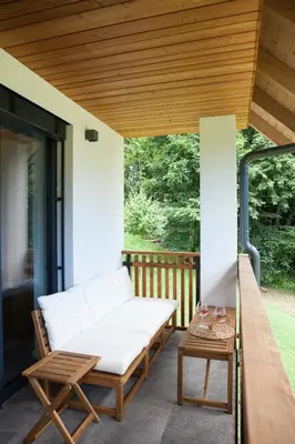 a porch with a bench and a table at Mlino Alpino in Bled