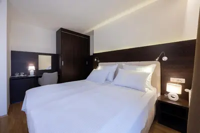 a large white bed in a hotel room at Rooms Bella in Bled