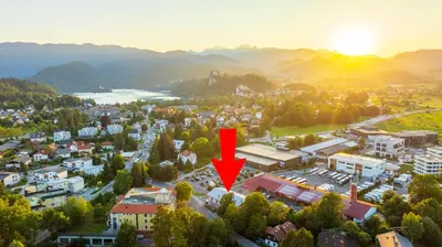 an aerial view of a city with a red arrow at Rooms Bella in Bled