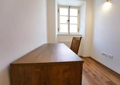 a wooden table in a room with a window at Apartments Metro 7 in Ljubljana