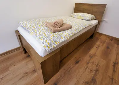 a bed with towels on it in a room at Apartments Metro 7 in Ljubljana