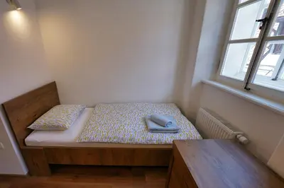 a room with a bed with two pillows and a window at Apartments Metro 7 in Ljubljana