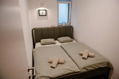 a bedroom with a bed with two towels on it at Apartment METULJ in Domžale