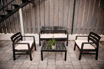 a table and two chairs and a table with a plant at Apartment METULJ in Domžale