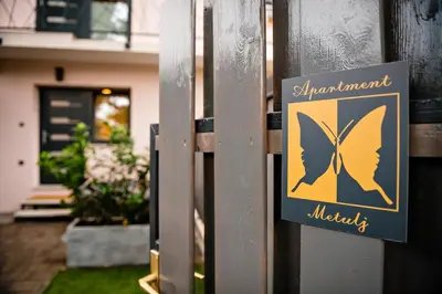 a sign with a butterfly on the side of a house at Apartment METULJ in Domžale