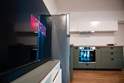 a kitchen with a refrigerator with a msg sign on it at Apartment METULJ in Domžale