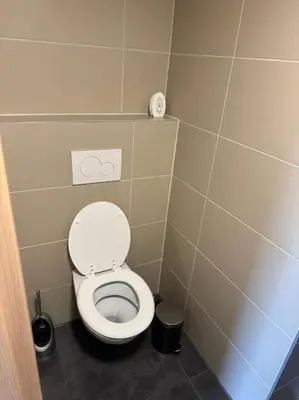 a small bathroom with a toilet in a stall at Beerpartment with parking in Ljubljana