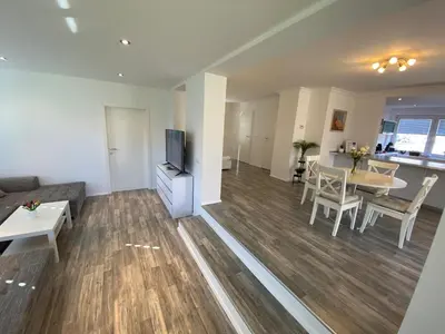 a living room with a couch and a table at Apartma Mimi in Bohinj