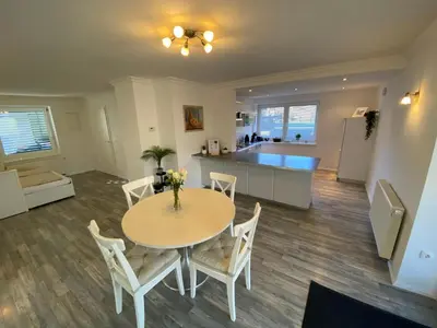 a dining room and kitchen with a table and chairs at Apartma Mimi in Bohinj