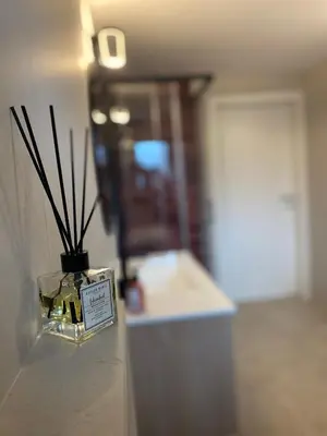 a vase with sticks in it sitting in a room at Apartma Mimi in Bohinj