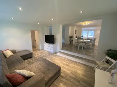 a living room with a couch and a television and a table at Apartma Mimi in Bohinj