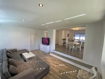 a living room with a couch and a tv at Apartma Mimi in Bohinj