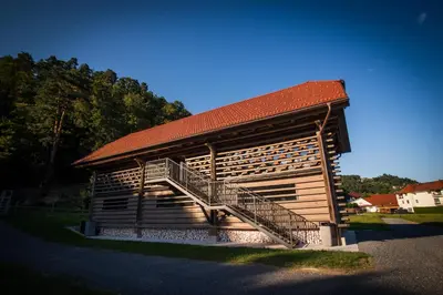 a large wooden building with a staircase on it at Hayrack Skok Mozirje in Mozirje
