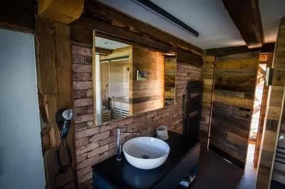 a bathroom with a sink and a mirror at Hayrack Skok Mozirje in Mozirje