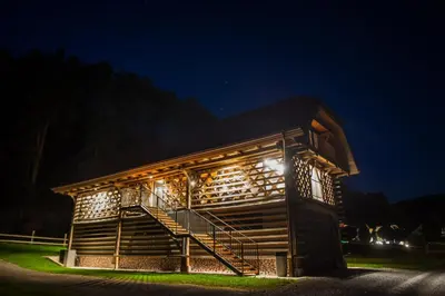 a building with lights on it at night at Hayrack Skok Mozirje in Mozirje