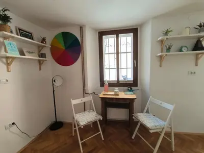 a room with a table and two chairs and a window at Glasbeni atelje Tri ptičice in Kranj