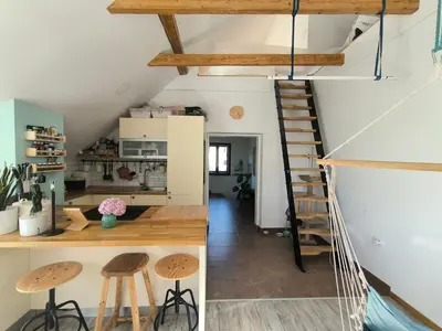 a room with a staircase and wooden stools at Glasbeni atelje Tri ptičice in Kranj