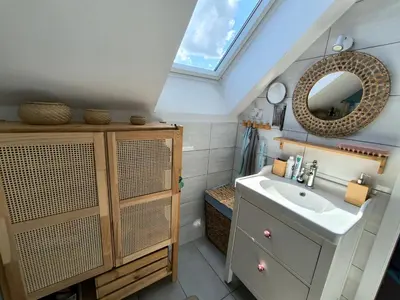 a bathroom with a sink and a mirror at Glasbeni atelje Tri ptičice in Kranj