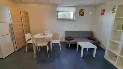 a small room with a table and a couch at Pool place in Petrovče
