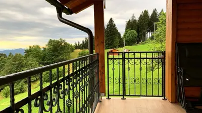a balcony with a view of a green field at Apartment Boris Sveta Planina in Knezdol