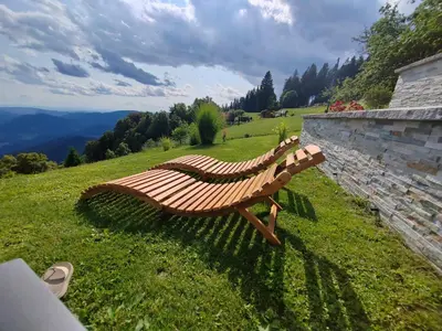 a bench sitting on top of a grassy hill at Apartment Boris Sveta Planina in Knezdol
