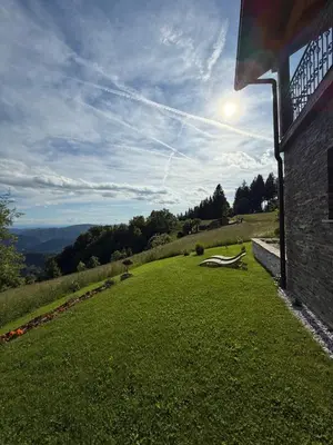 a view of a field of grass next to a building at Apartment Boris Sveta Planina in Knezdol