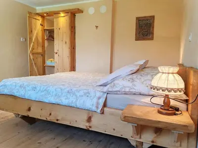 a bedroom with a bed with a lamp on a table at Riverdance with mountain view, garden and private parking in Bled