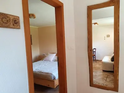 a bedroom with a bed and a mirror at Riverdance with mountain view, garden and private parking in Bled