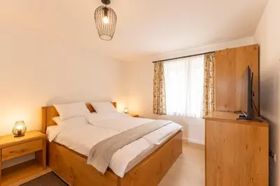 a bedroom with a large bed and a window at Roland House with Pool & Winery in Stara Vas-Bizeljsko