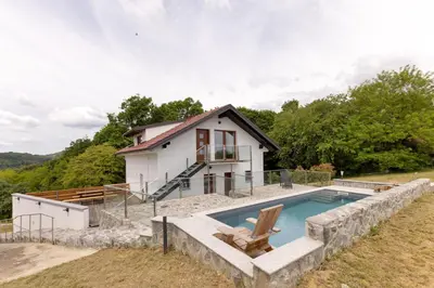 a home with a swimming pool and a house at Roland House with Pool & Winery in Stara Vas-Bizeljsko
