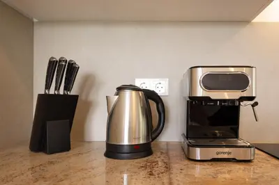 a coffeemaker and a coffee maker on a counter at Roland House with Pool & Winery in Stara Vas-Bizeljsko