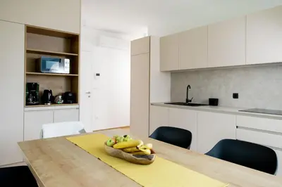 a kitchen with a table with a bowl of fruit on it at Prosecco apartment in Bovec