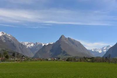 a green field with mountains in the background at Prosecco apartment in Bovec