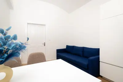a living room with a blue couch and chairs at MM NEW cozy modern apartment in Ljubljana