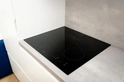 a black stove top oven in a kitchen at MM NEW cozy modern apartment in Ljubljana