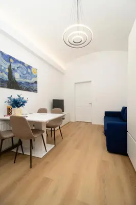 a living room with a blue couch and a table at MM NEW cozy modern apartment in Ljubljana