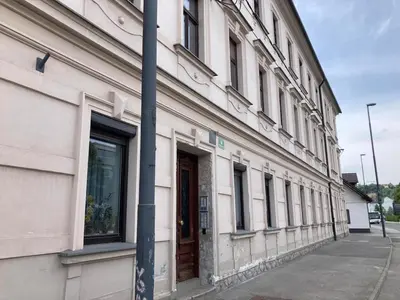 a building with a pole next to a street at MM NEW cozy modern apartment in Ljubljana