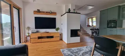 a living room with a flat screen tv on a wall at Vila Zavino in Branik