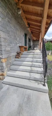 a stone building with stairs and a wooden roof at Vila Zavino in Branik