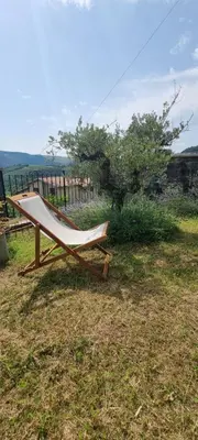 a hammock sitting on the grass in a field at Vila Zavino in Branik