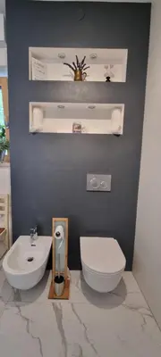 a bathroom with a white toilet and a sink at Vila Zavino in Branik