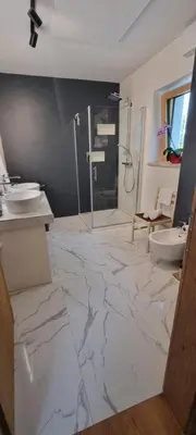 a bathroom with a marble floor and a shower at Vila Zavino in Branik