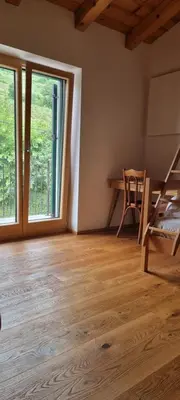 a room with a bed and a desk and windows at Vila Zavino in Branik