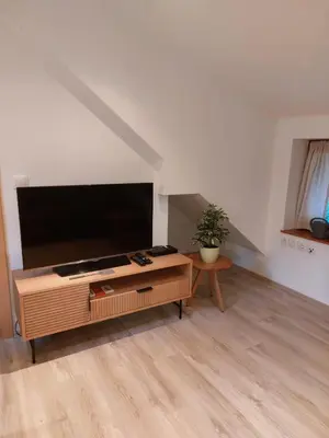 a living room with a large flat screen tv at Ferienwohnung Bohinj in Bohinjska Bistrica